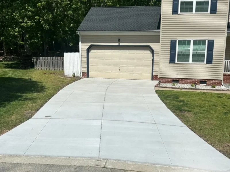 Newly installed concrete driveway beside a home project